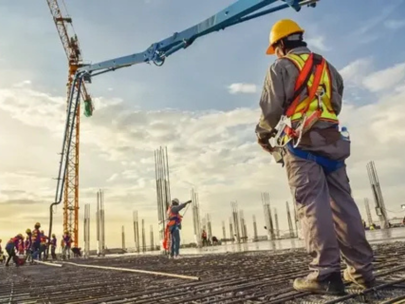 Construction takeoff process with workers measuring rebar and concrete work on site by ALM Estimating