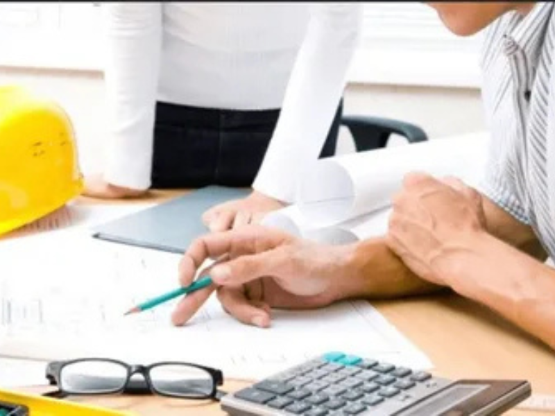 Engineers reviewing construction plans and costs for ALM Estimating’s preliminary estimating services